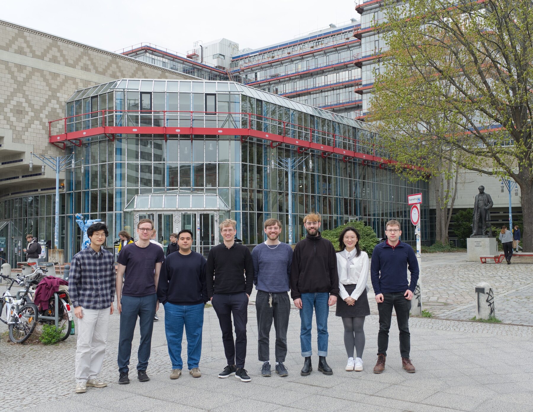 Members of the SAiS group standing together outside the university building